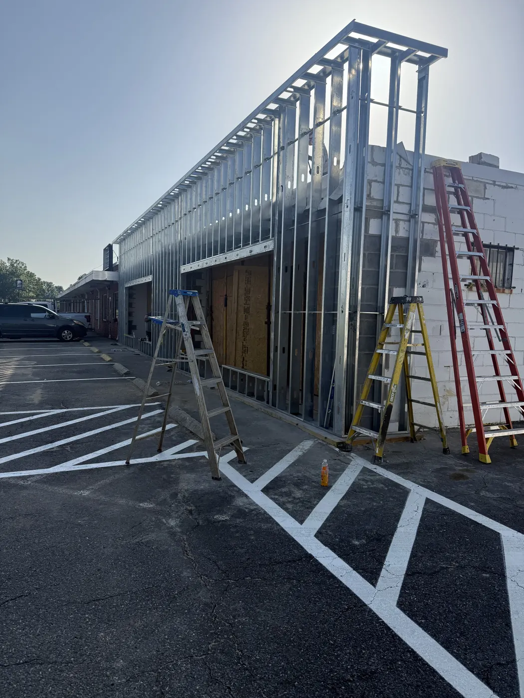 Metal stud framing installation at an active commercial site
