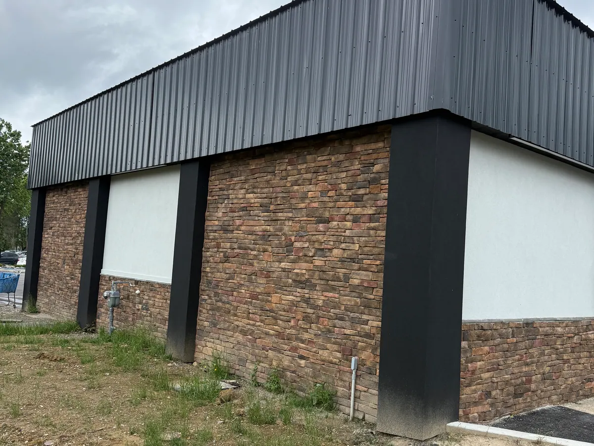 Exterior of a commercial service facility with coordinated cladding and masonry