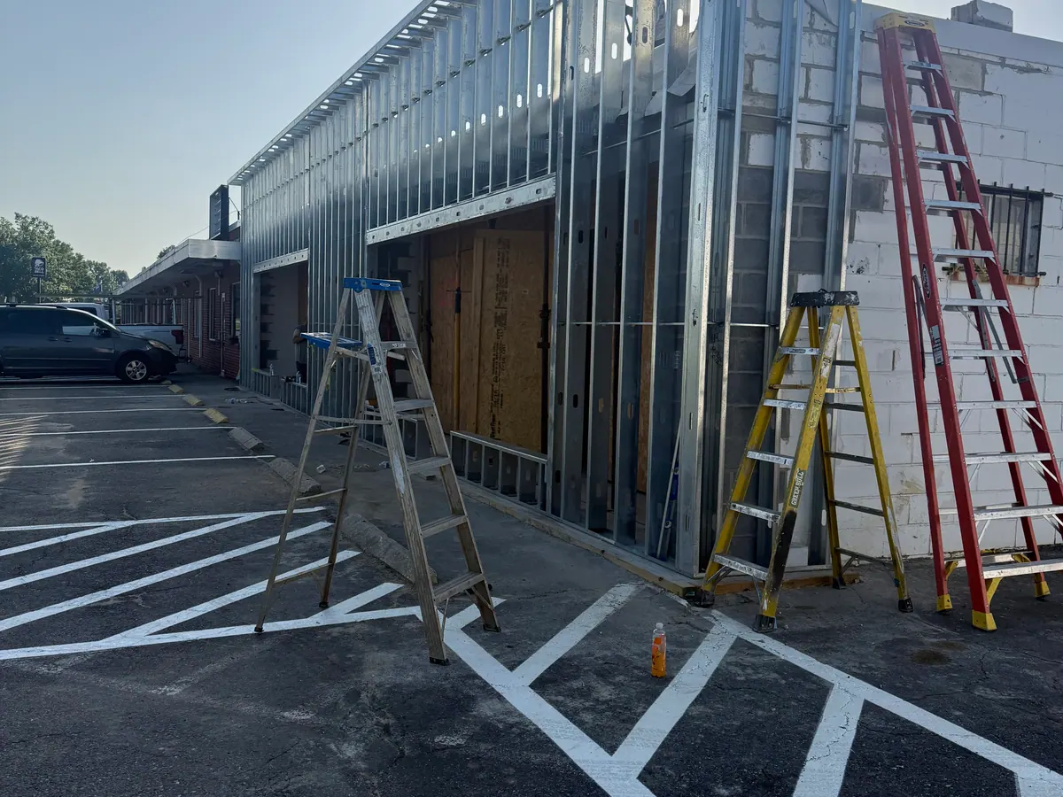 Commercial framing work area with ladders and coordinated wall openings