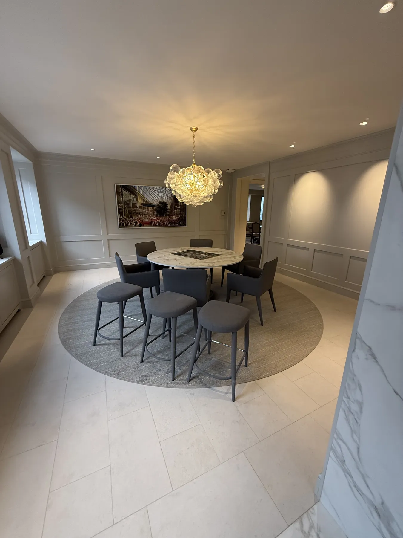 Finished dining area with detailed cabinetry and wall moulding
