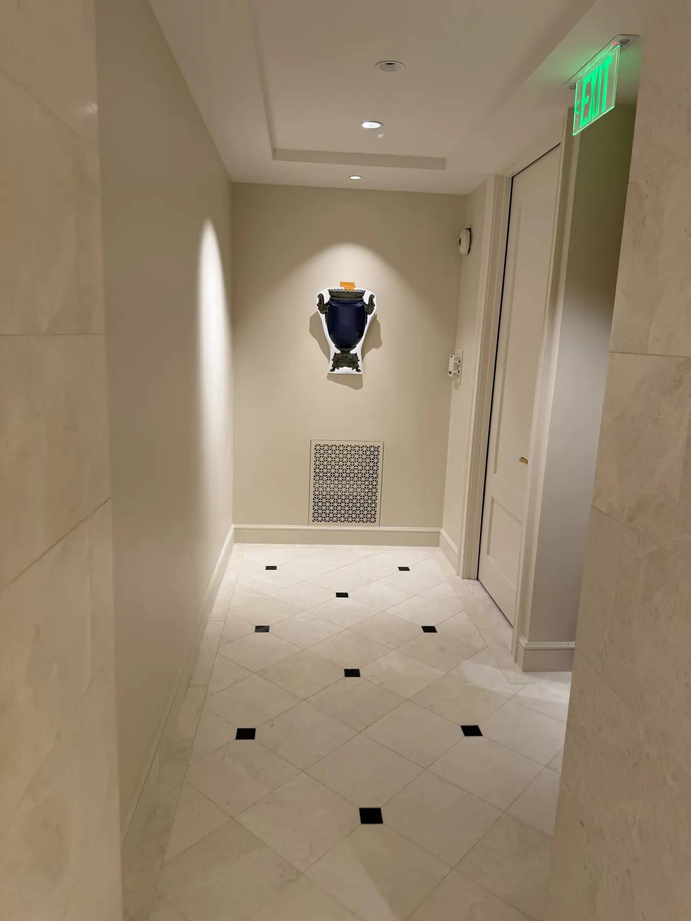 Finished corridor showing wall panels, flooring, and a decorative feature