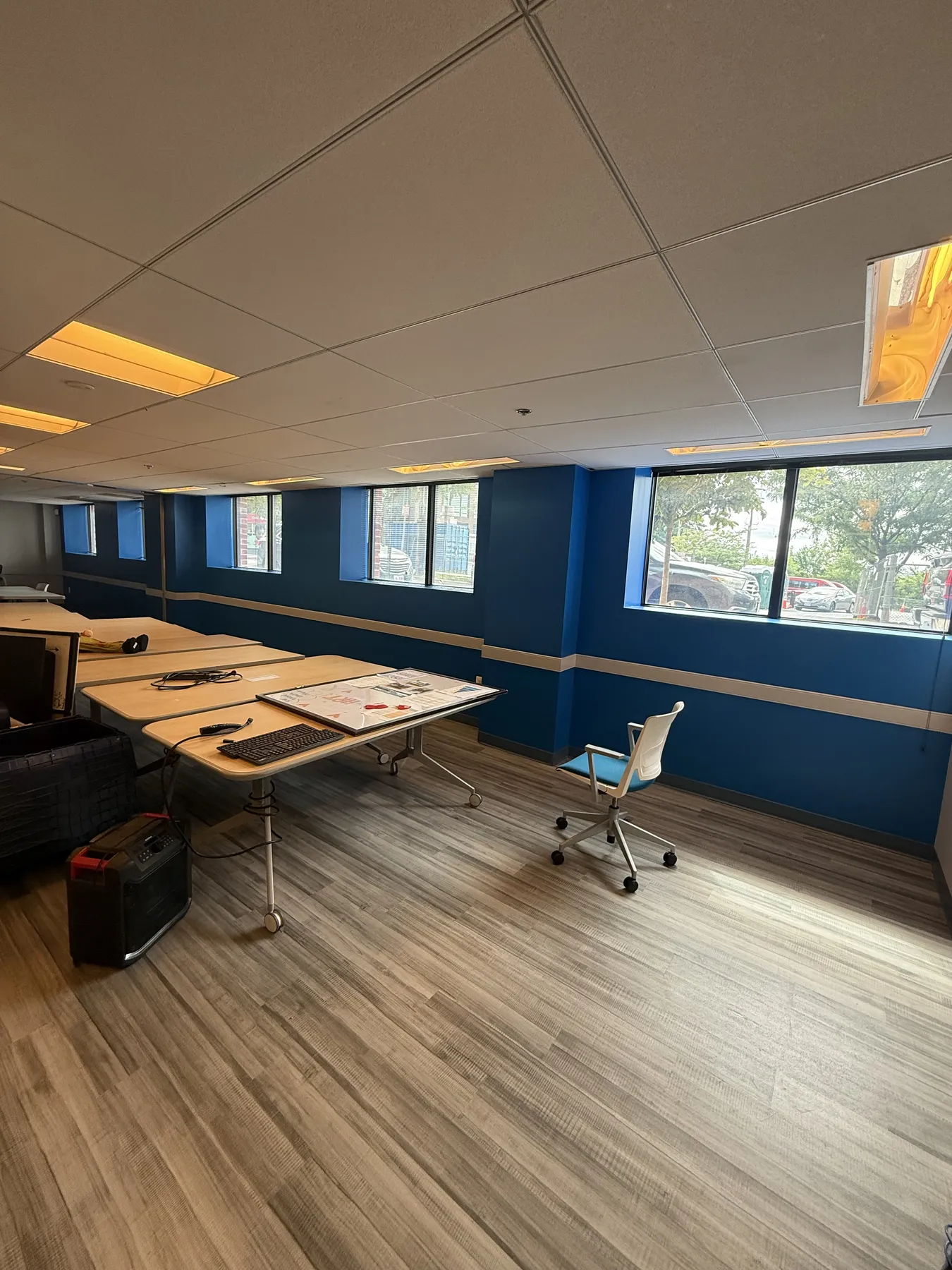 Completed commercial workplace with desks and an acoustical ceiling