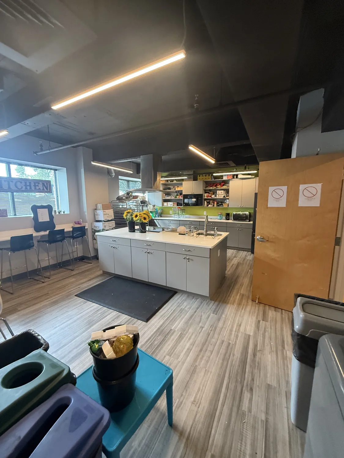 Completed commercial workplace interior showing coordinated walls, ceilings, openings, and finishes